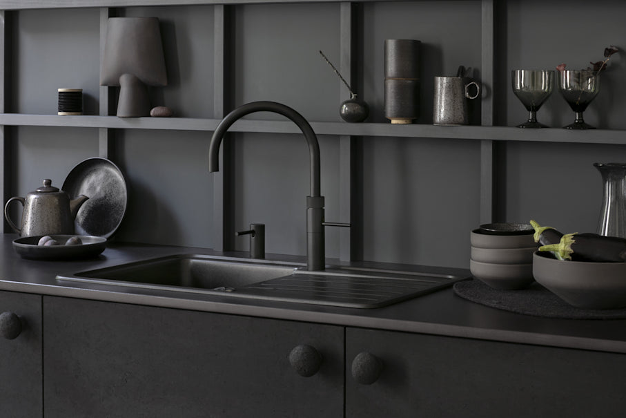 Luxury kitchen sink and tap integrated into a stone worktop